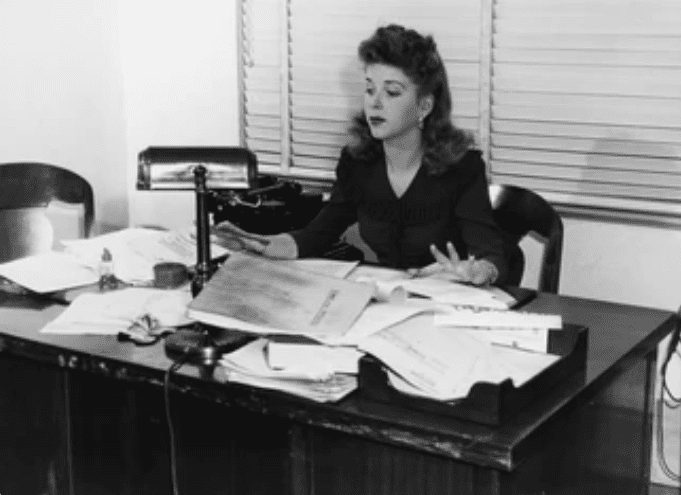 Black and white picture of a messy desk