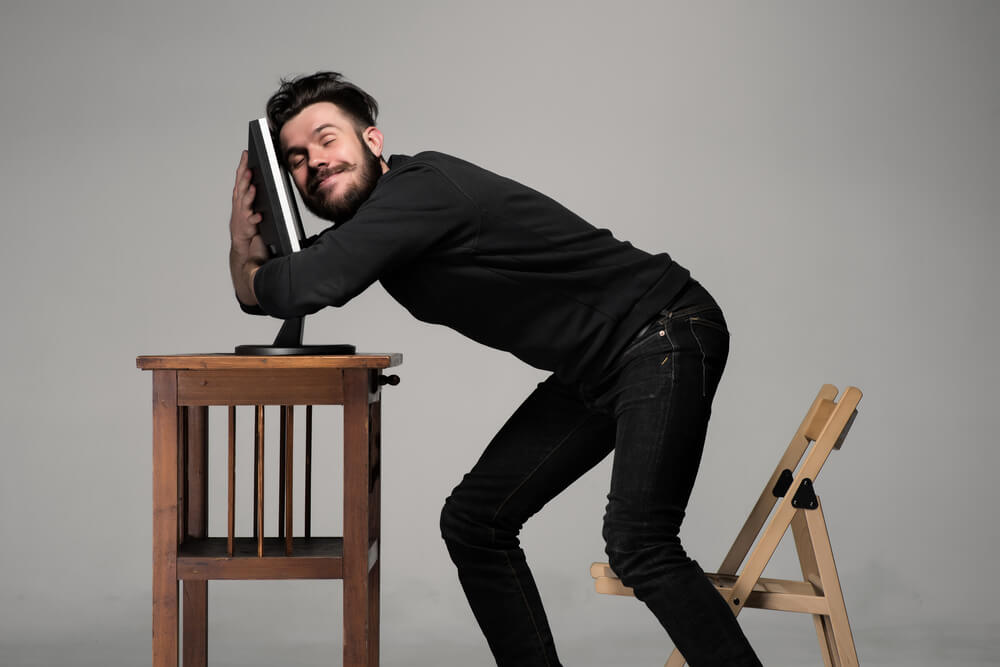 Man Hugging Computer Man hugging a computer.