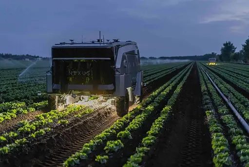 A Nexus robot driving through field picking weeds.